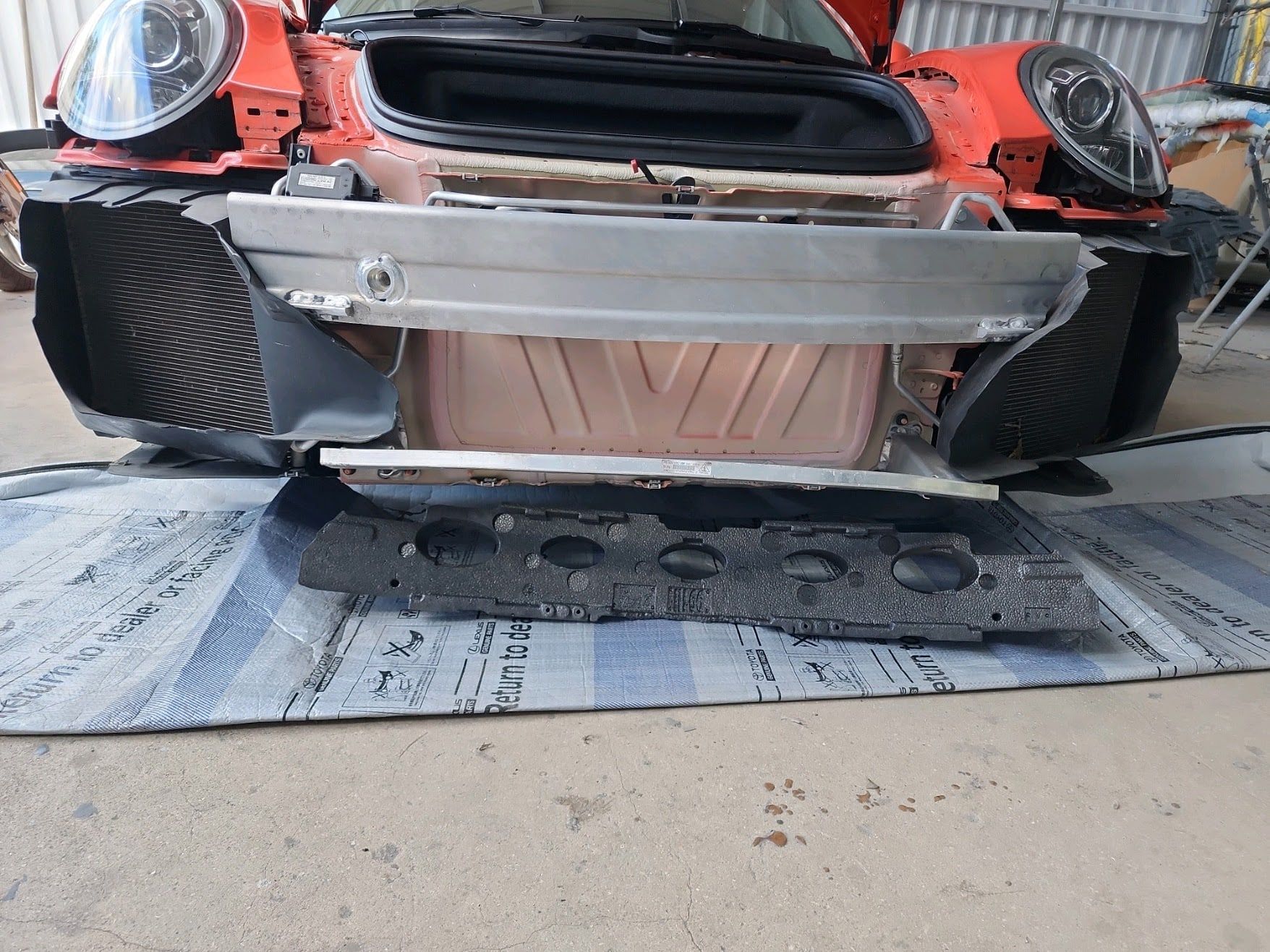 The same Porsche with the bumper removed, showing the crash bar